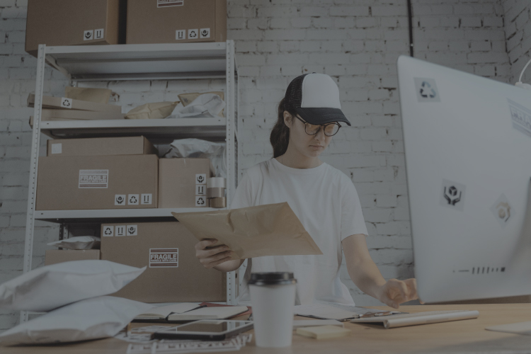 Warehouse Worker Reviewing Sales Order and Packing the shipment